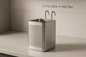 A sleek stainless steel kitchen utensil holder with a perforated design displayed on a modern kitchen countertop, embodying the premium Kitchen + Metal aesthetic