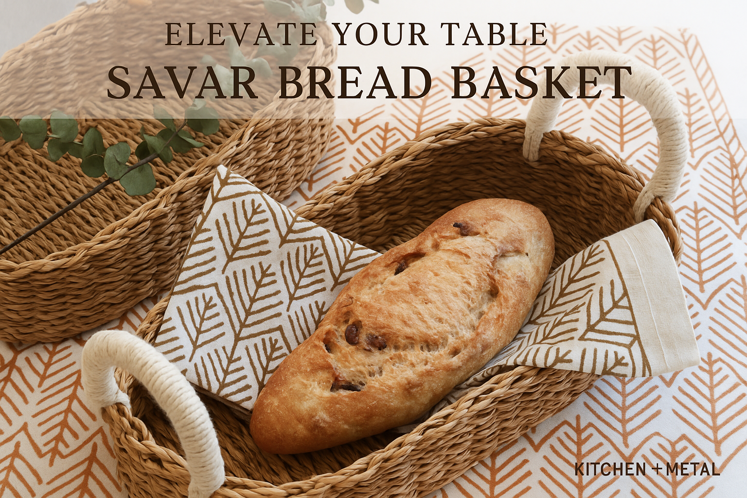 A styled product photo of a Savar Bread Basket with artisan bread, eucalyptus sprigs, and Kitchen + Metal branding