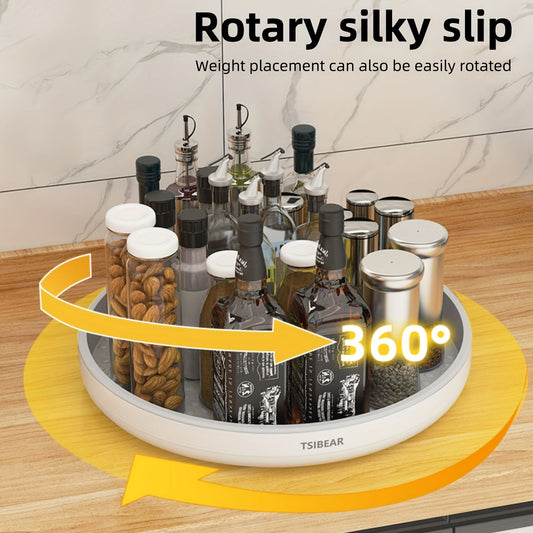 A 360-degree rotating white kitchen organizer with a selection of bottles and containers on a circular base, placed on a kitchen counter.