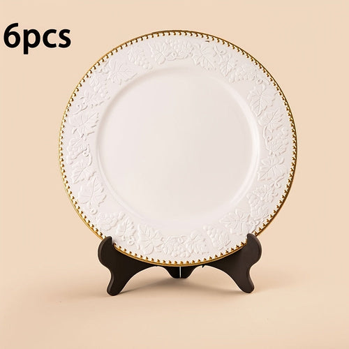 A white and gold decorative charger plate with an intricate floral pattern around the edge, measuring 33 cm (13 inches).