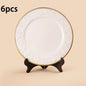 A white and gold decorative charger plate with an intricate floral pattern around the edge, measuring 33 cm (13 inches).