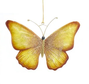 Gold glitter butterfly ornament on a white background
