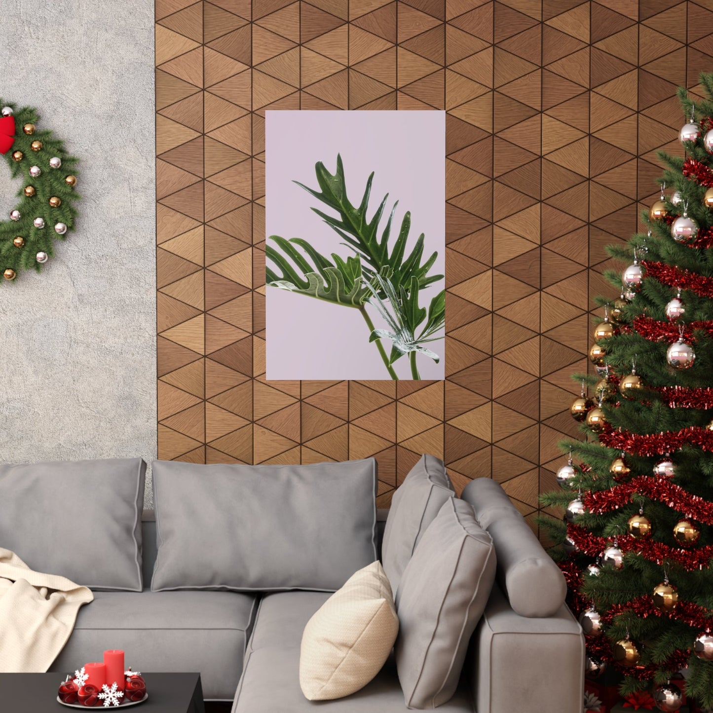 Living room with a gray sofa, Christmas tree, and geometric wall design.