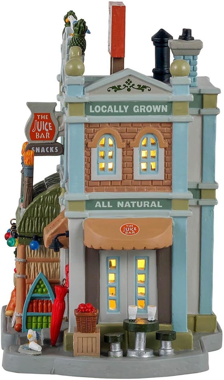 Decorative model of a small town street with buildings and signs.