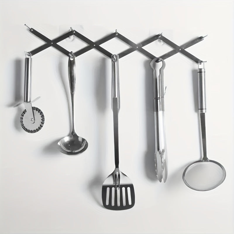 stainless steel drying rack holding kitchen tools on wall