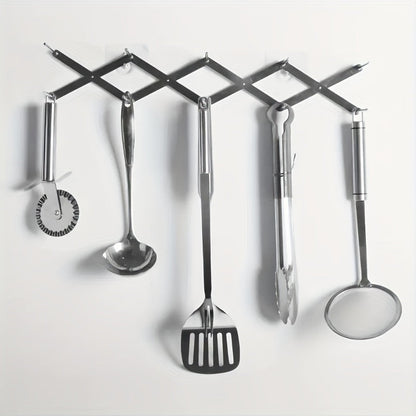 stainless steel drying rack holding kitchen tools on wall