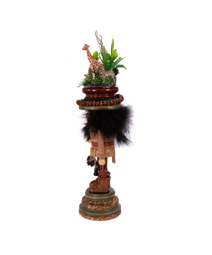 Decorative figure with a zebra, giraffe, and other animals on top of a stack of stones.