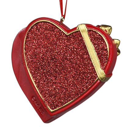 Red glittery heart-shaped box with gold accents on a white background