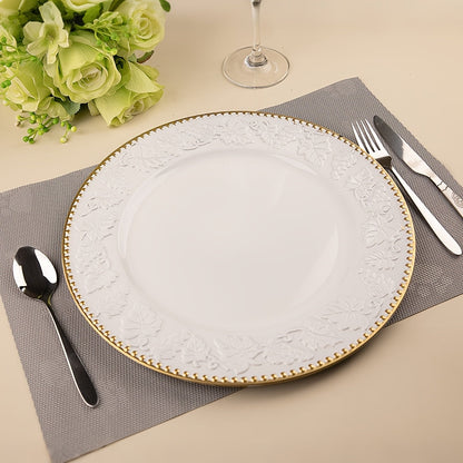 Elegant white plate with gold rim on a table setting.