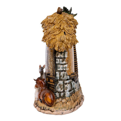 Decorative miniature structure with thatched roof and animals on a white background