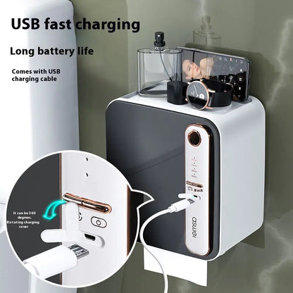 White electronic device with charging cable, perfume bottle, and smartphone on a gray surface.