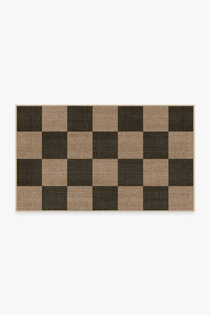 Checkered rug with brown and beige squares on a white background