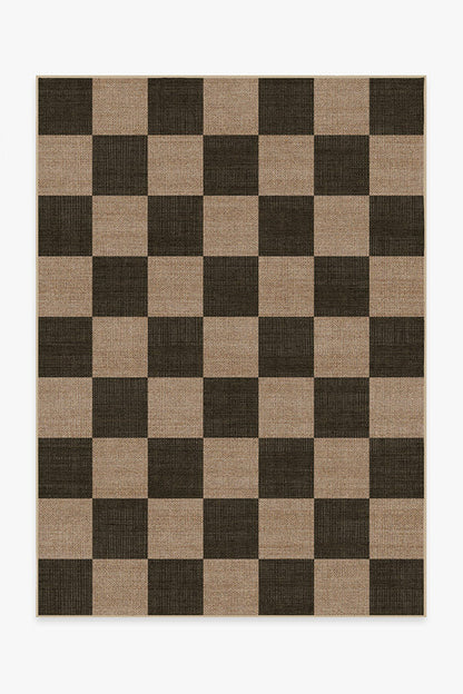 Checkered rug with brown and beige squares on a white background