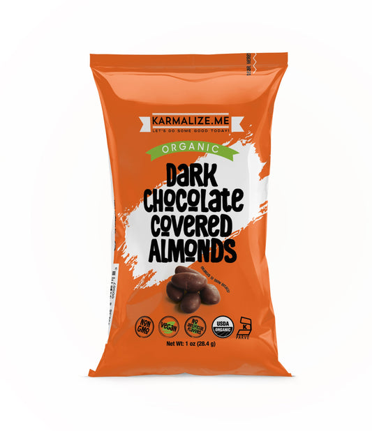A package of Karmaize Me Organic Dark Chocolate Covered Almonds, 1 oz, with visible almonds through a transparent window and the brand's logo on the orange packaging.