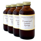 Four bottles of Morris Kitchen Preserved Lemon Syrup, each labeled 8oz.