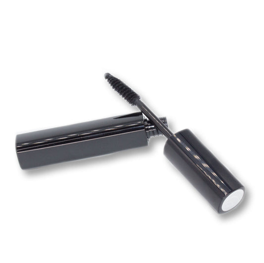 Black mascara with open cap on a white background