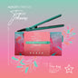 Green hair straightener with packaging on a pink and green gradient background, featuring 'Almost Famous' branding.