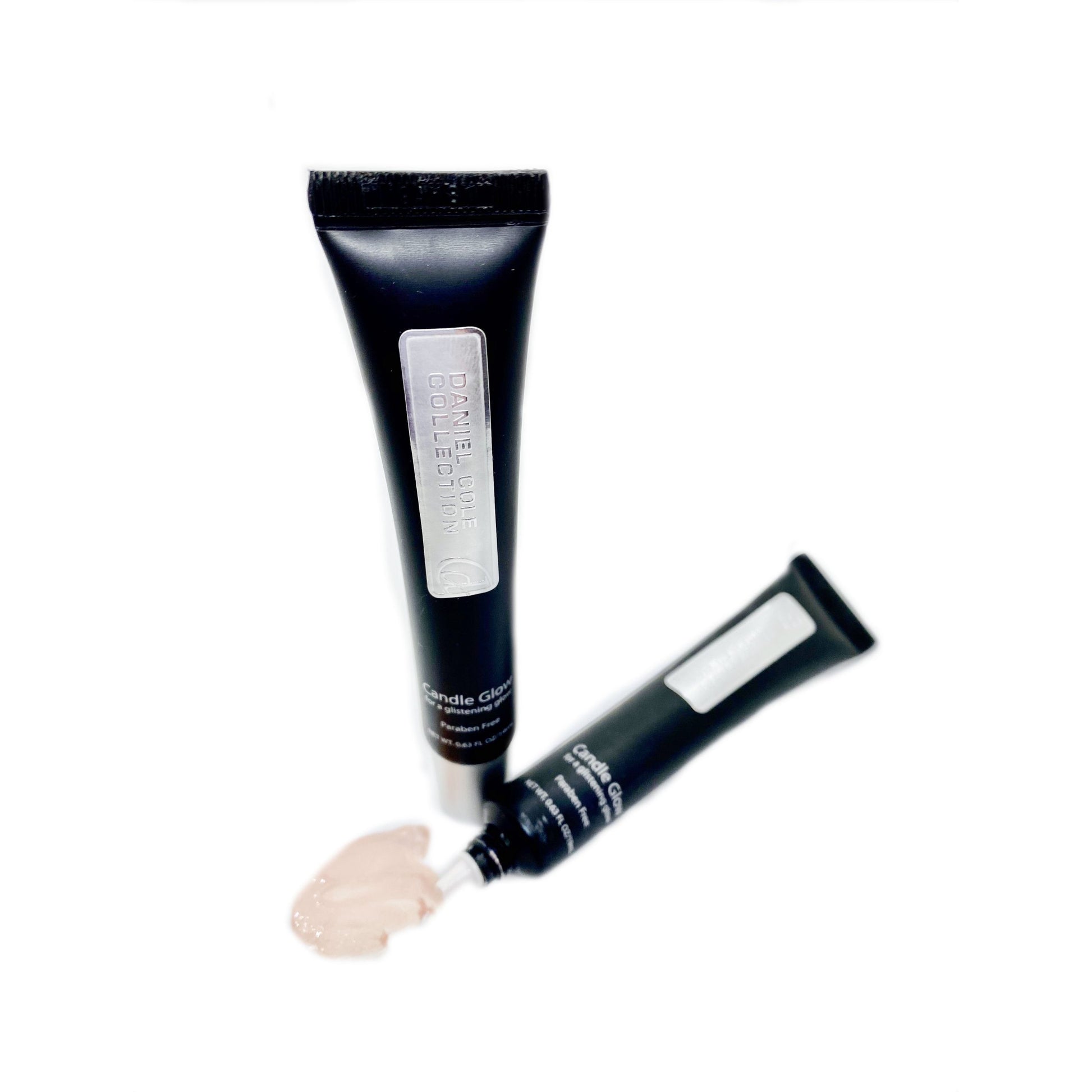 Two black cosmetic tubes with white labels on a white background