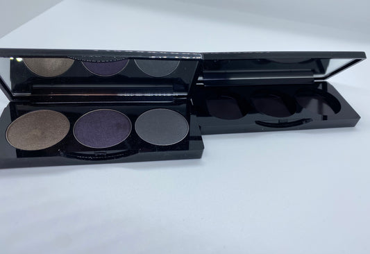 Makeup palette with three circular shades on a white background