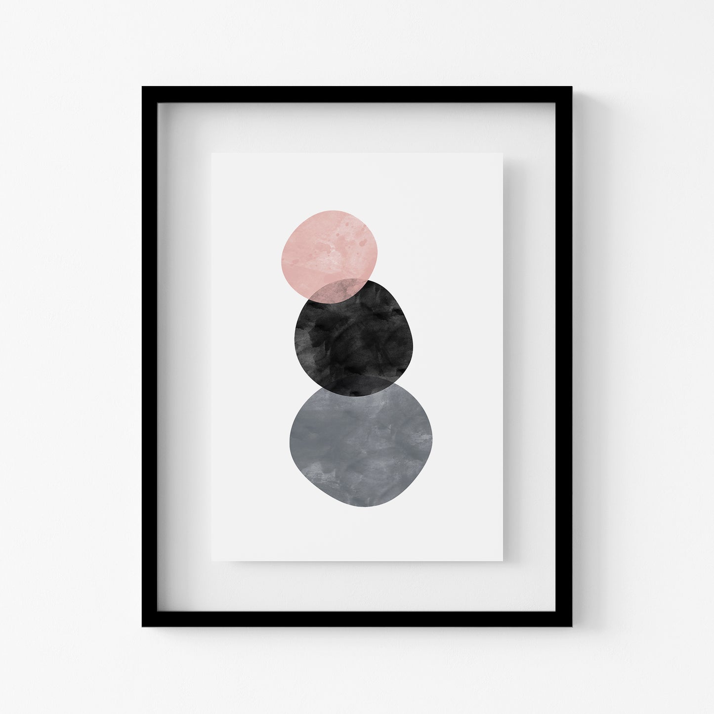 Framed abstract art print with pink, black, and gray circles on a white background