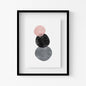 Framed abstract art print with pink, black, and gray circles on a white background