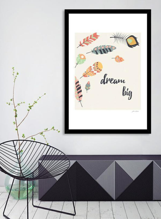 Framed artwork with feather illustrations and 'dream big' text in a modern interior setting.