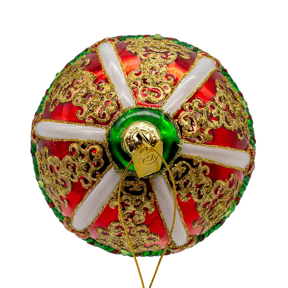 Decorative ball with gold patterns, red and green colors on a white background