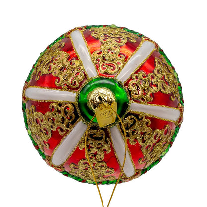 Decorative ball with gold patterns, red and green colors on a white background