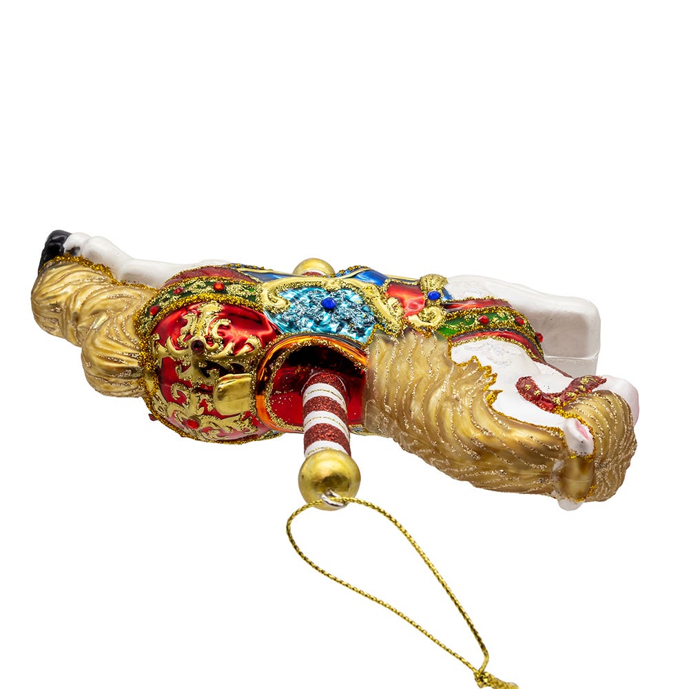 Decorative figurine with intricate designs and a string for hanging on a white background