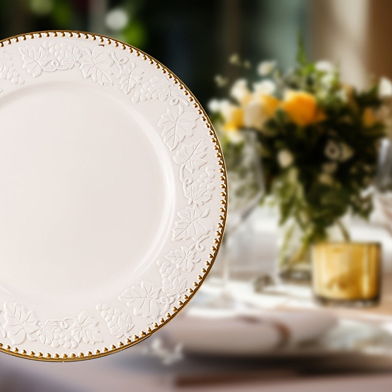 Decorative white plate with gold rim on a table setting.