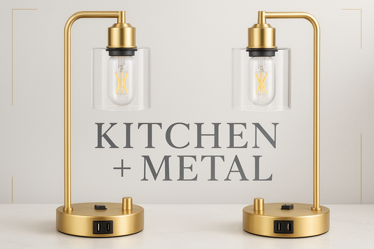 Elegant gold desk lamps with clear glass shades displayed against a sophisticated background featuring the Kitchen + Metal logo in a modern font with subtle metallic texture