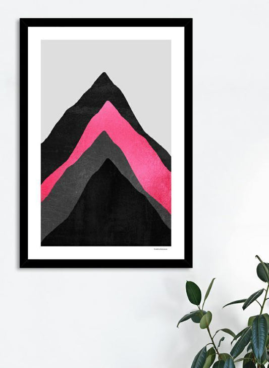 Framed abstract art print with pink and black design on a white wall.