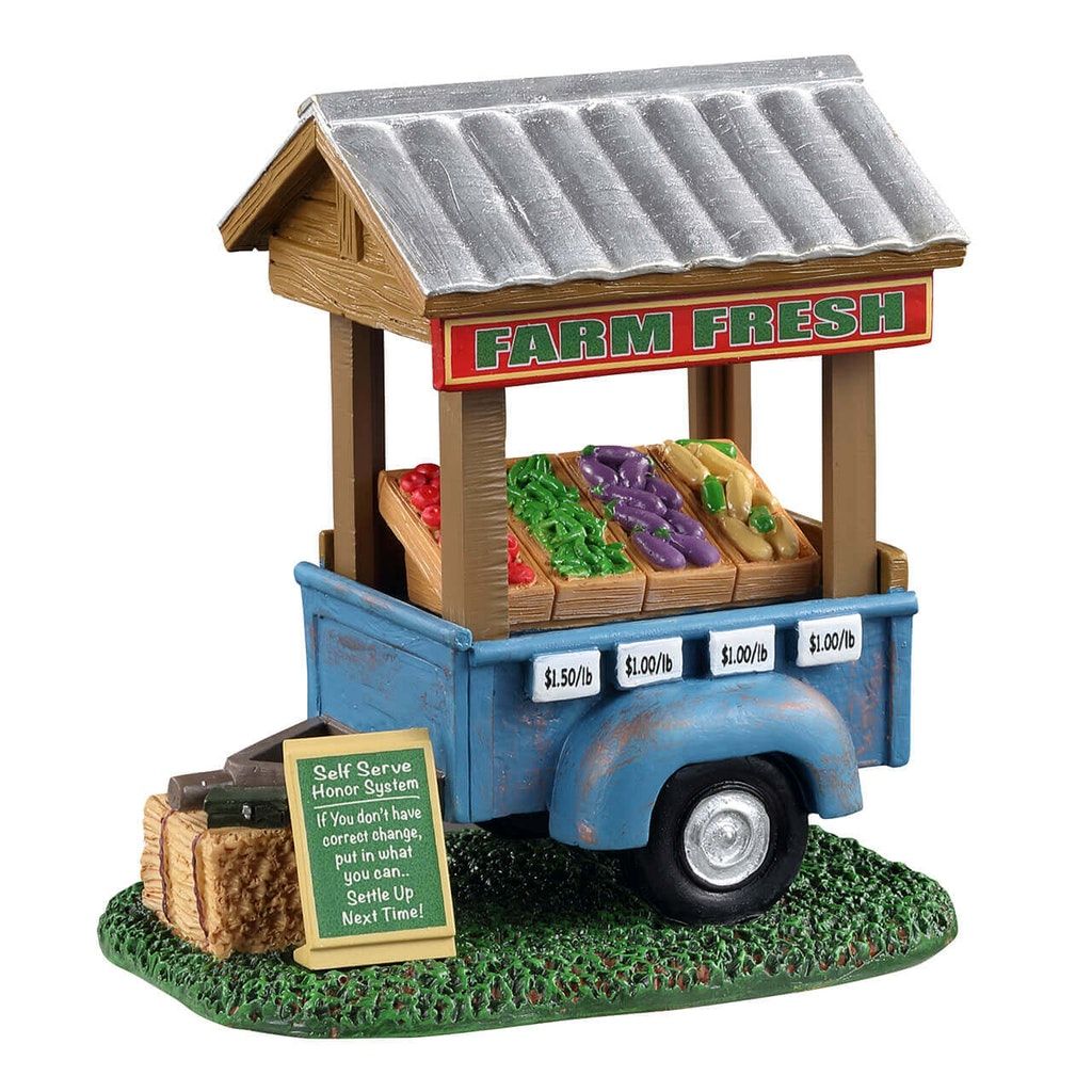Model of a farm fresh stand with vegetables and pricing on a white background