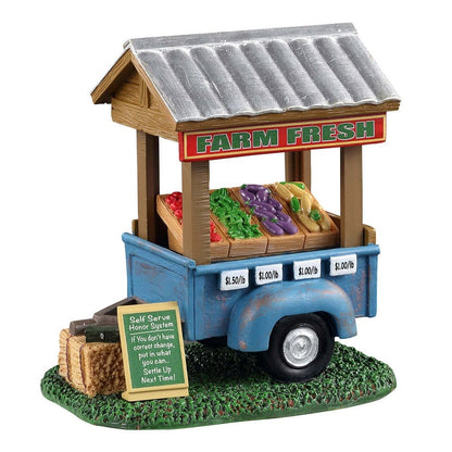 Model of a farm fresh stand with vegetables and pricing on a white background