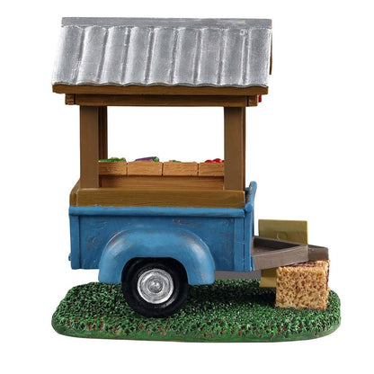 Model of a blue food truck with a wooden top on a white background