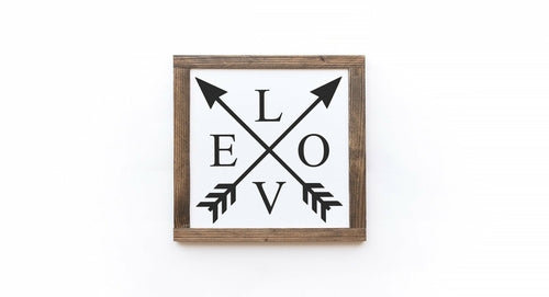 Decorative sign with crossed arrows and 'LOVE' on a white background