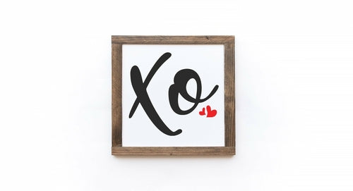 Framed artwork with 'Xo' and a heart on a white background