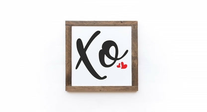 Framed artwork with 'Xo' and a heart on a white background
