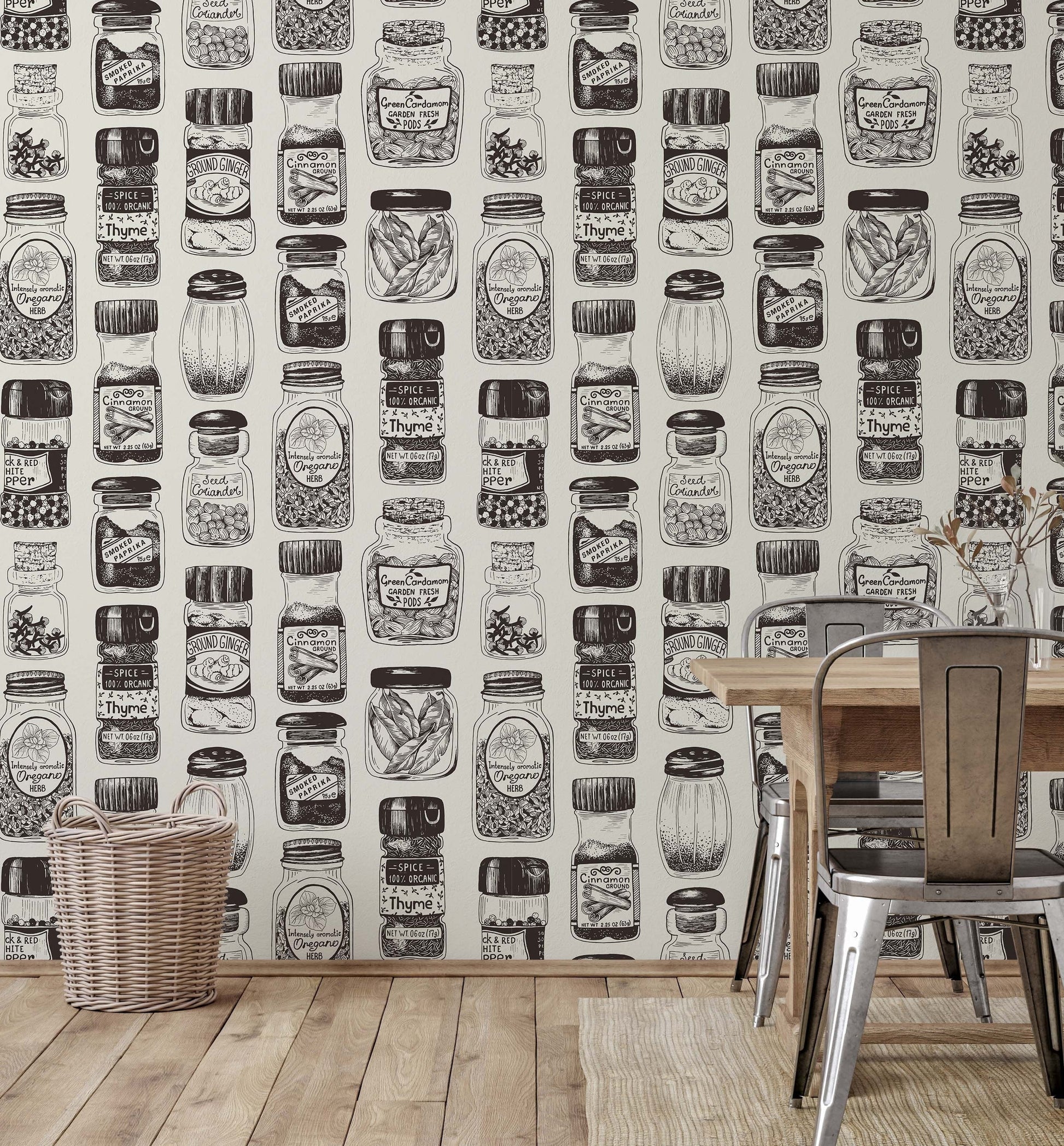 A section of wallpaper with a vintage spice rack design, featuring black and white illustrations of various herbs and spices, displayed in a room setting with a table and chairs.