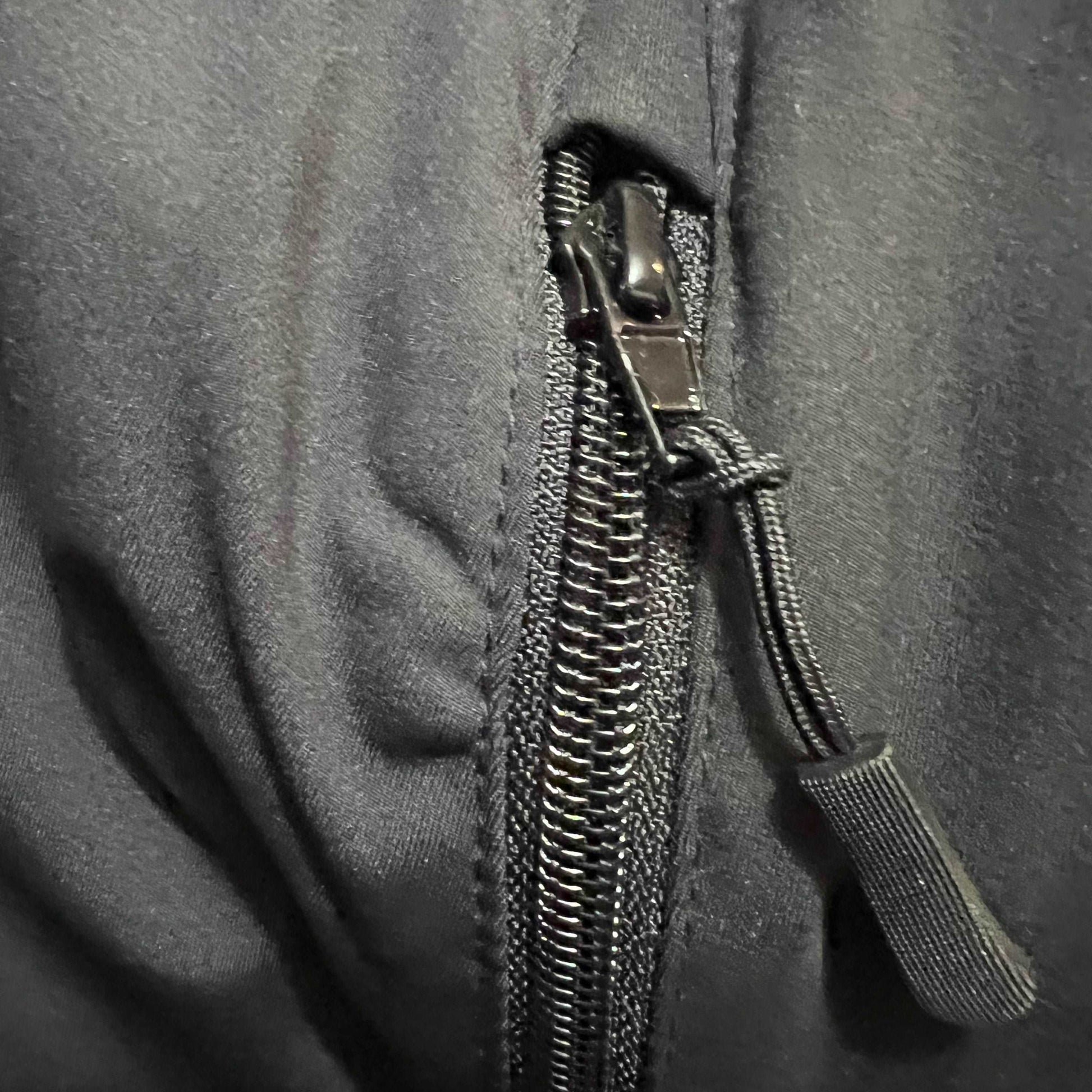 Close-up of a zipper on a gray fabric background