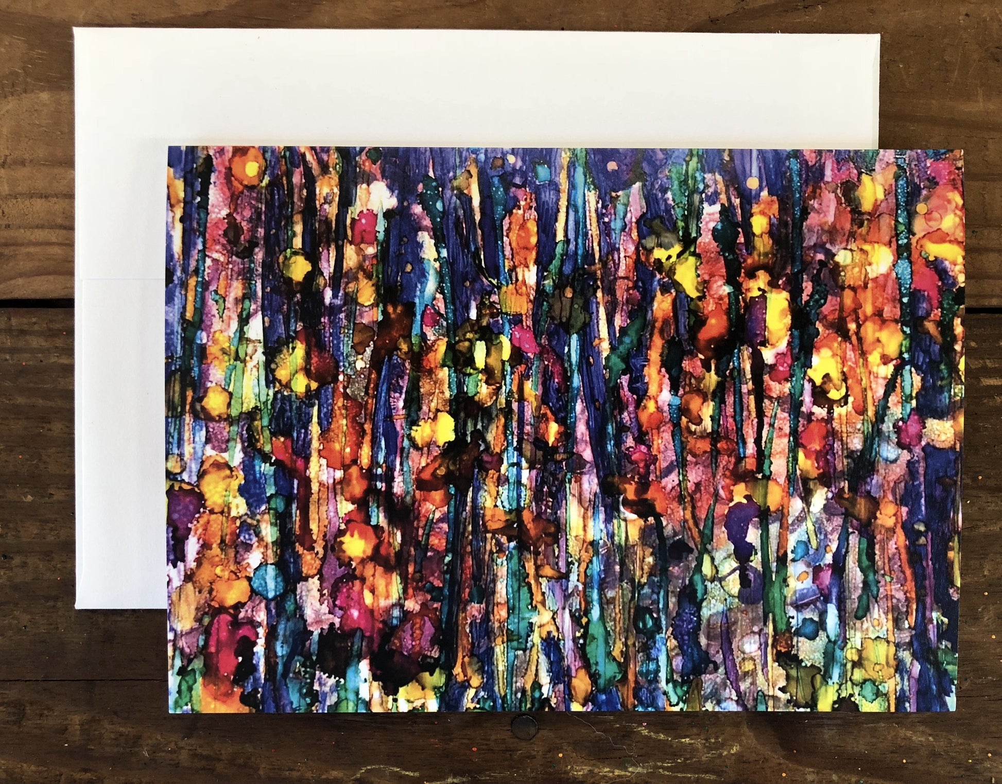 Colorful abstract art card on a wooden surface