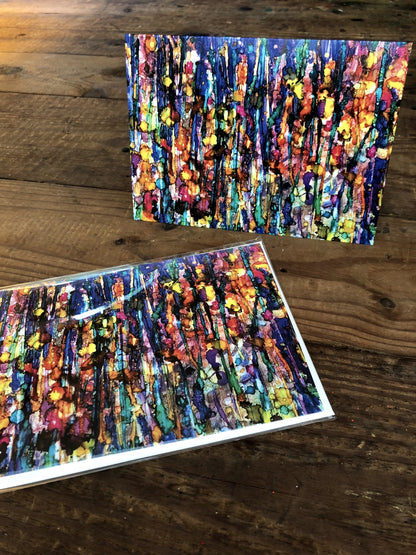 Two colorful abstract paintings on a wooden surface