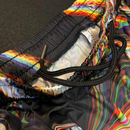 Close-up of a colorful jacket with a black cord, on a dark background