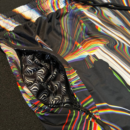 Multicolored abstract patterned jacket with a black and white patterned pocket.