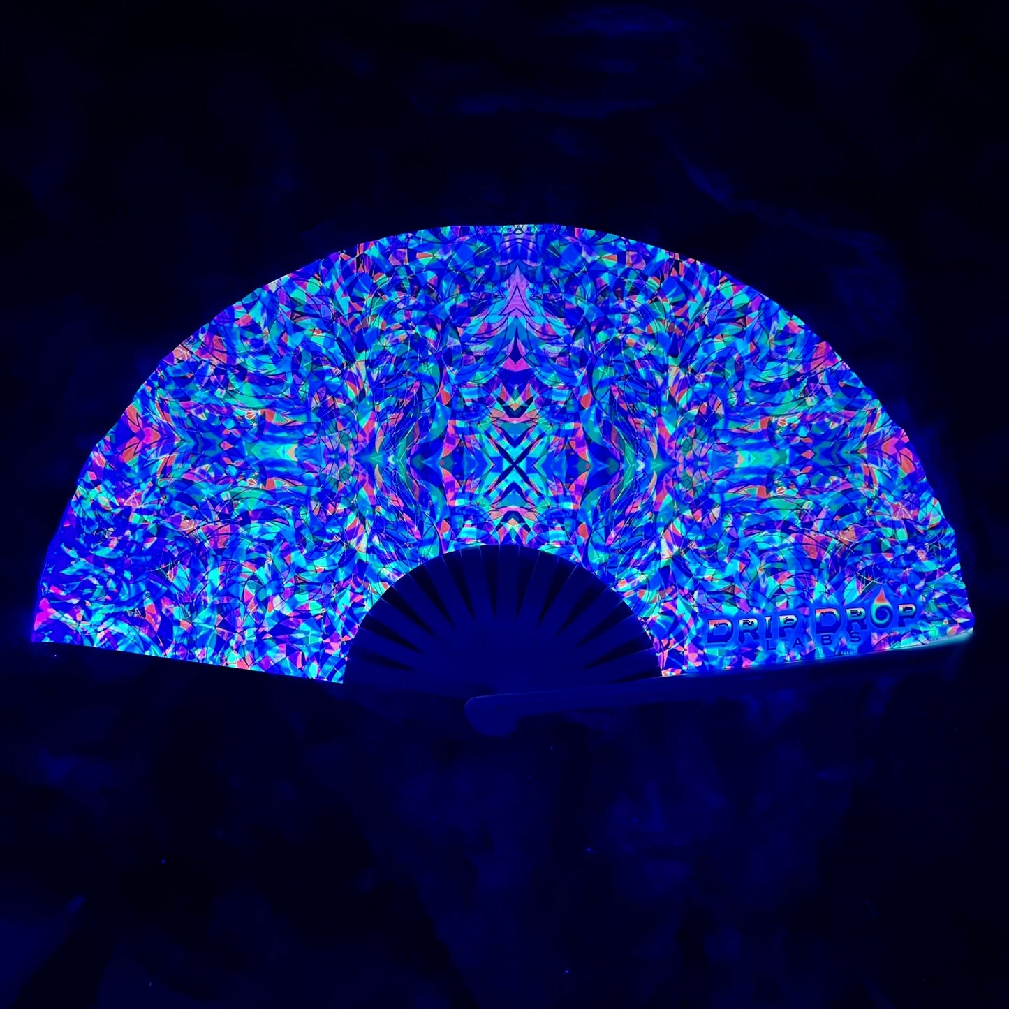 Colorful patterned fan against a dark background