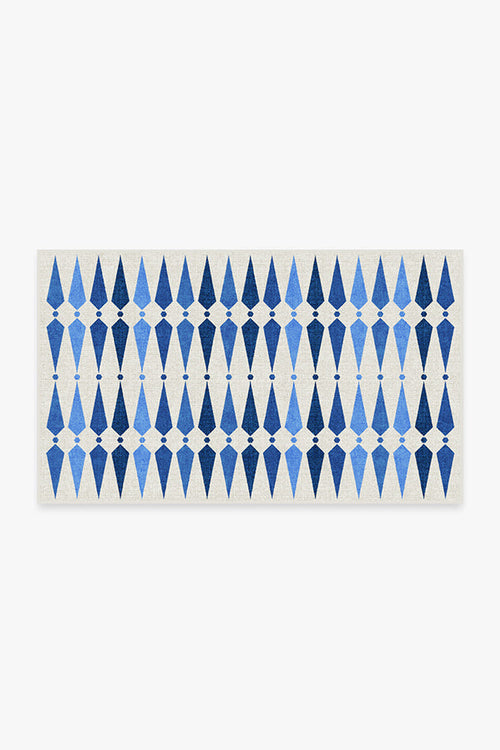 Rectangular mat with blue geometric pattern on a white background