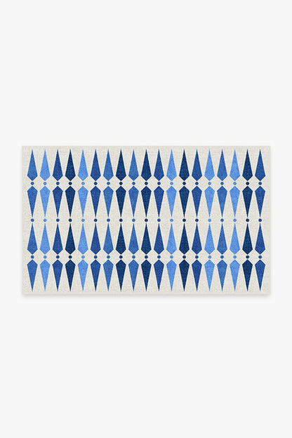 Rectangular mat with blue geometric pattern on a white background