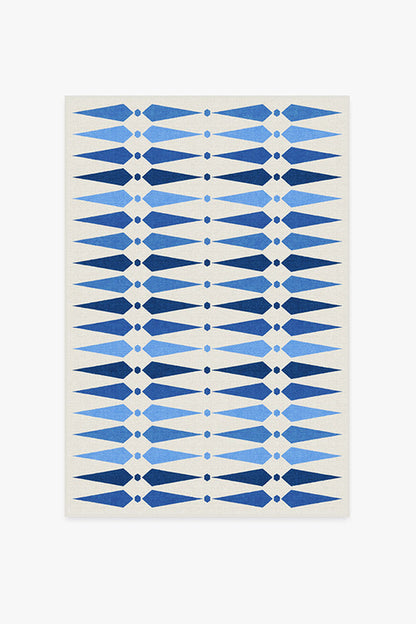 Rug with blue geometric pattern on a white background