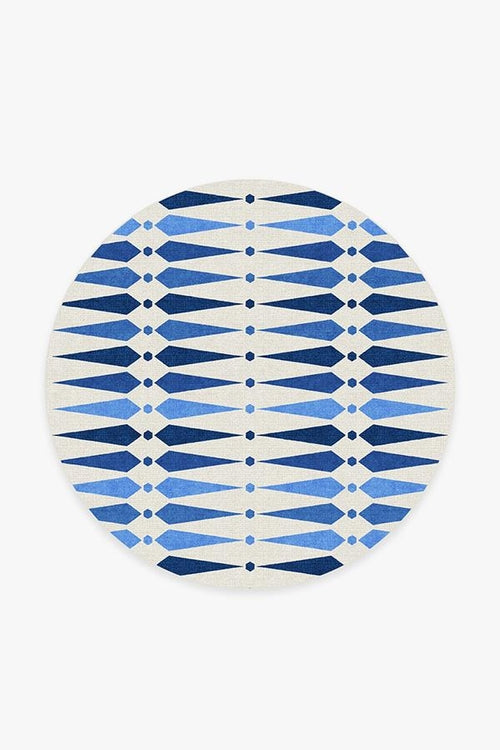 Round blue and white patterned rug on a white background
