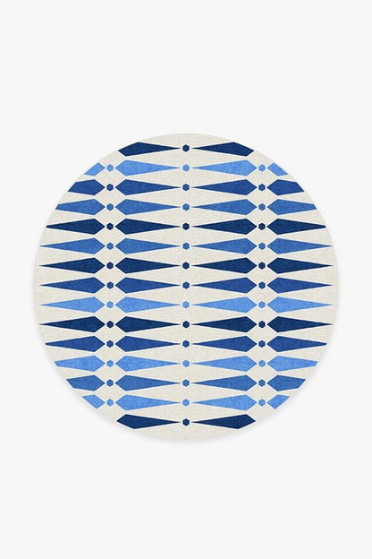 Round blue and white patterned rug on a white background